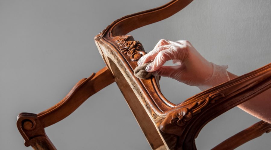 polishing furniture with hard wax oil and woolen cloth. all details back, armrest, leg. Repair of old furniture like an old Victorian old wooden armchair.